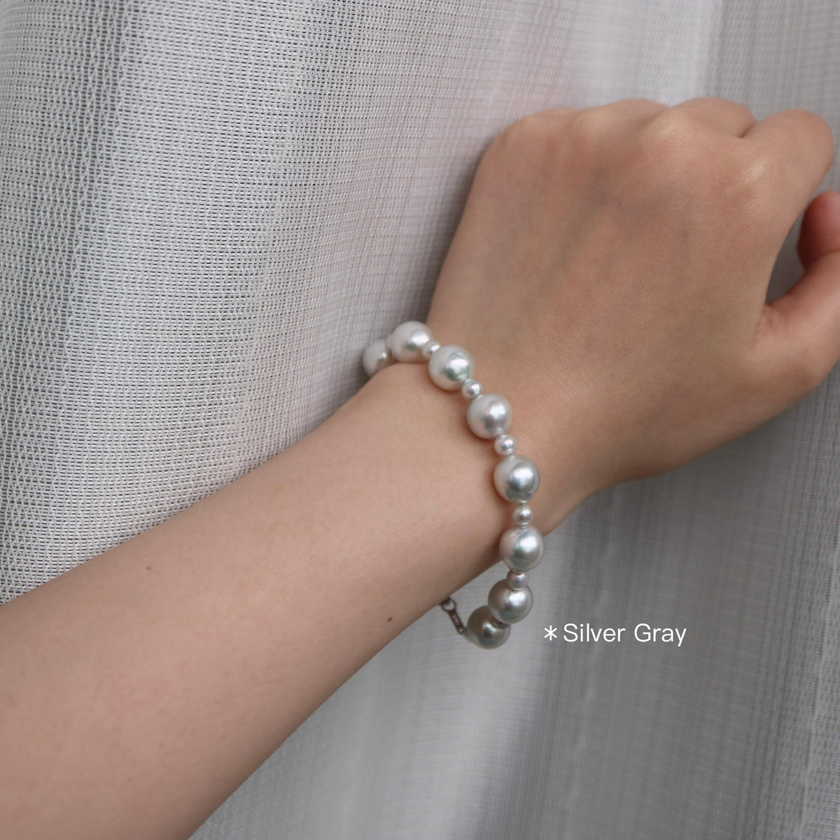 Silver gray Akoya pearl bracelet on wrist, handmade Japanese seawater pearls, elegant minimalist design