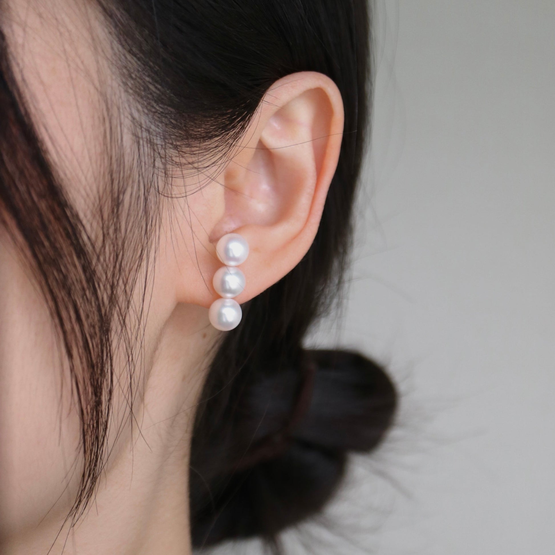 Three pearl drop earrings on ear, handmade Japanese Akoya pearls, elegant minimalist design