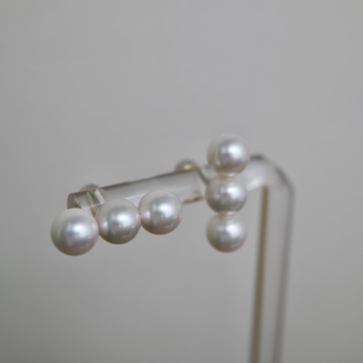Lustrous Japanese Akoya pearl earrings, hand-selected seawater pearls on display stand