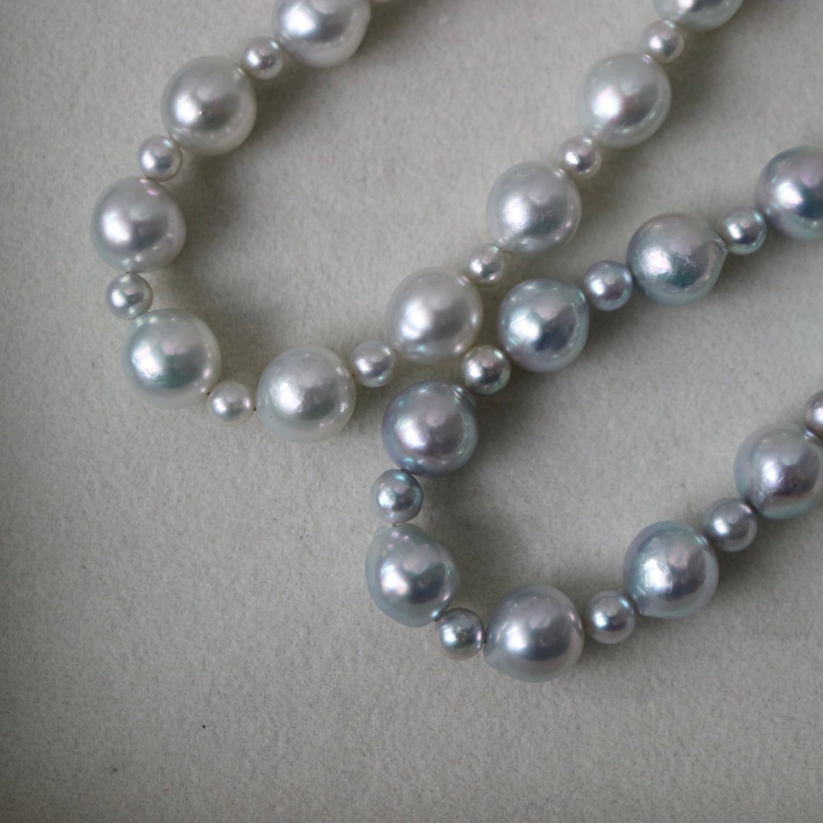 Handmade Japanese Akoya pearl necklace with lustrous white and silver pearls, unedited photo