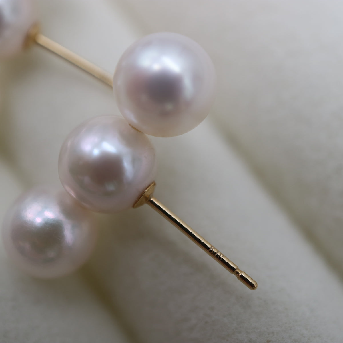 Japanese Akoya pearl stud earrings with 18K gold posts, showcasing lustrous white pearls and elegant craftsmanship