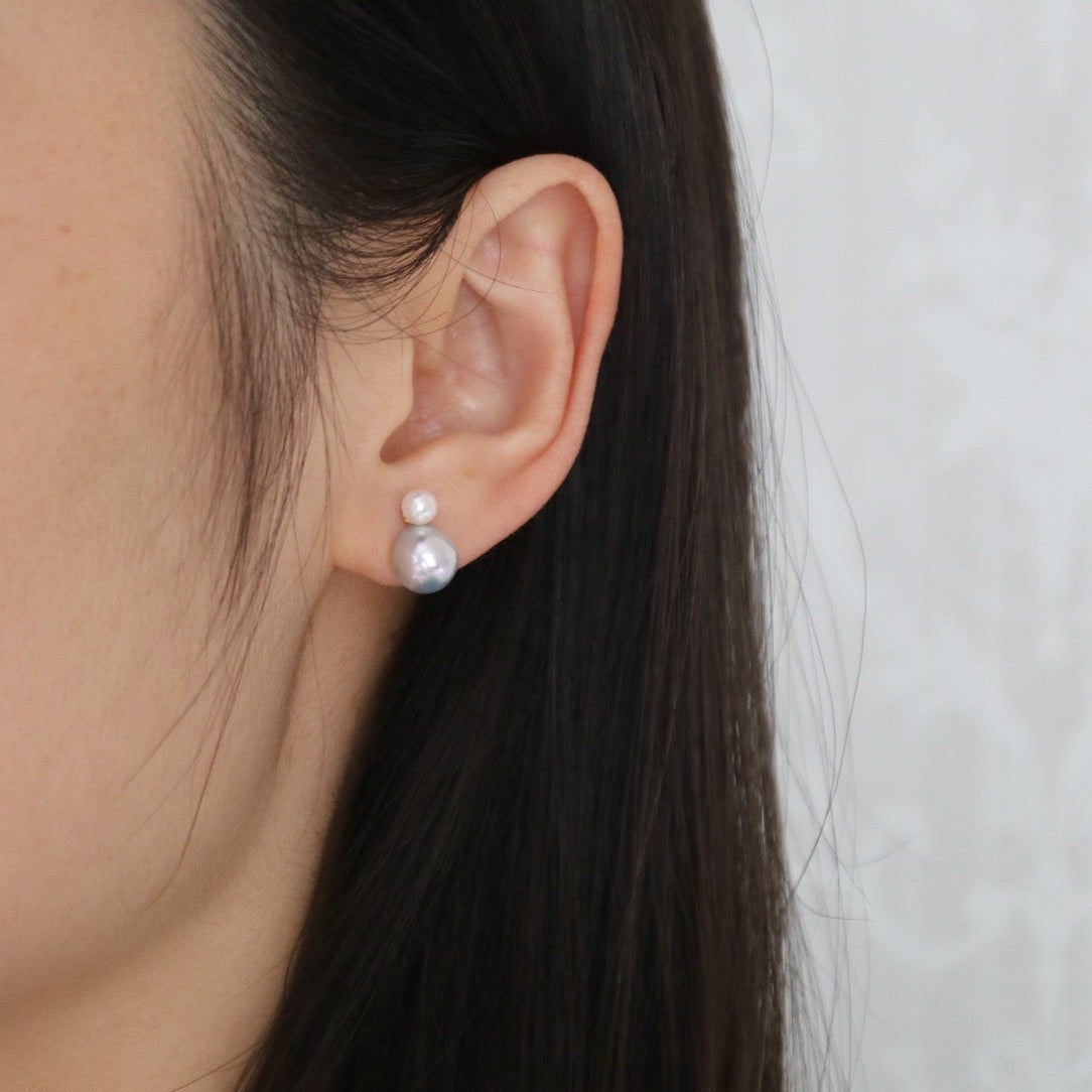 Close-up of a woman wearing double-layered Japanese Akoya pearl earrings.