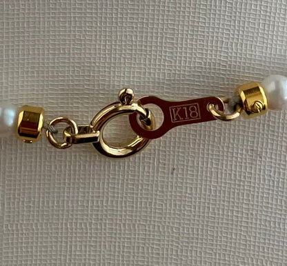 18K gold clasp on Japanese Akoya pearl bracelet, K18 hallmark visible, handmade luxury jewelry